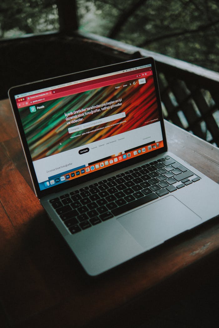 The Art of Drawing Readers In: Your attractive post title goes here A close-up view of a laptop with a website open, placed on a wooden table near a window.
